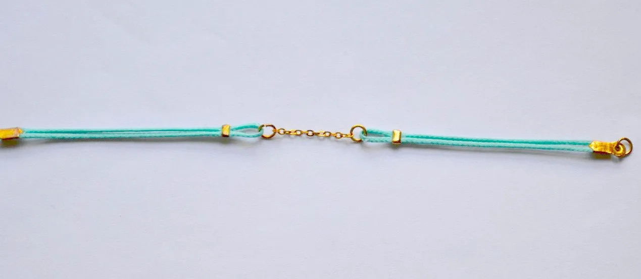 Turquoise cord bracelet with a gold chain