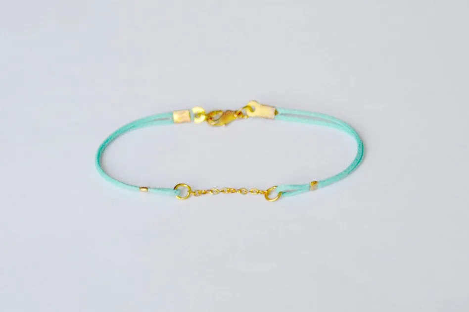 Turquoise cord bracelet with a gold chain